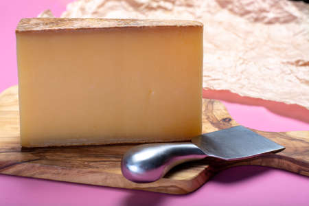 Piece of aged Comte or Gruyere de Comte, AOC French cheese made from unpasteurized cow's milk in the...