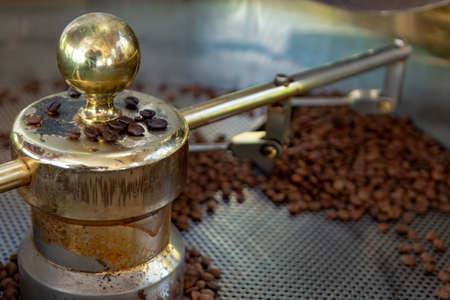 Traditional method of roasting dried organic arabica  coffee beans in roster with open grid for...