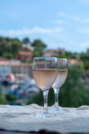 Rose wine of Provence, France, served cold on outdoor terrace in two wine glasses in sunny dayの写真素材