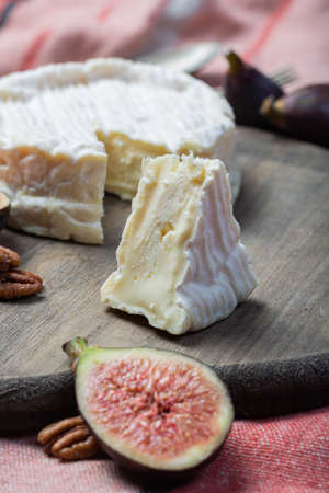 French soft Camembert cheese, original Camembert de Normandie served with fresh ripe figs and...