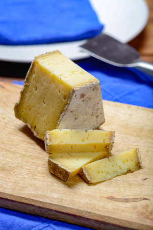 Piece of French Tomme cheese, produced in French Alps and in Switzerland close-upの写真素材