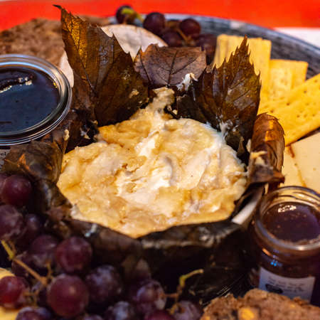 Dessert cheese plate with Castagnino Italian Goat Robiola soft cheese in Chestnut Leaves served with...