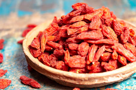 Healthy superfood, red dried goji chinese wolfberry berries, used in many snack foods and supplements, granola bars, yogurt, tea blends, fruit juice as whole berries or ground seeds, seed oil close up.の写真素材