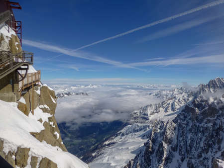 View from highest panoramic platform on mountain peak Aiguille du Midi in France above ski village...