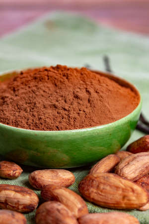 Cocoa or cacao beans and powder, used in hot chocolate drink, chocolate, butter and solids close upの写真素材
