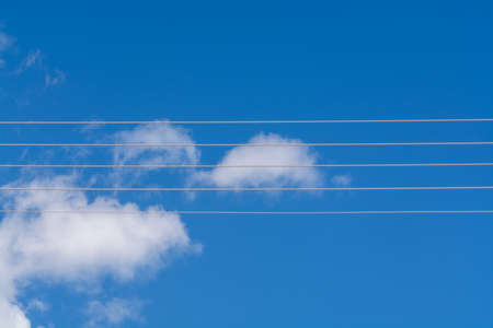 Empty music staff concept photo of 5 electric wires on blue sky, music creation template copy space