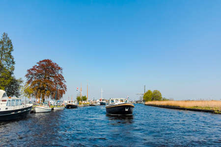 Landscape with waterways and canals of North Holland with boats, canal-side lifestyle in The Netherlandsの写真素材