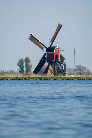 Waterways of North Holland and view on traditional Dutch wind mill, Dutch lifestyle landscapeの写真素材