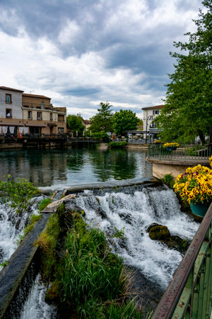 Tourist and vacation destination, view on small Provencal town lIsle-sur-la-Sorgue with green water of Sotgue river, South of Franceのeditorial素材