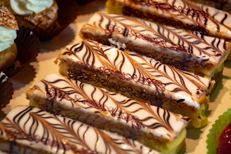 Freshly baked stuffed sweet Millefeuille pastries in traditinal French bakery in small village in...