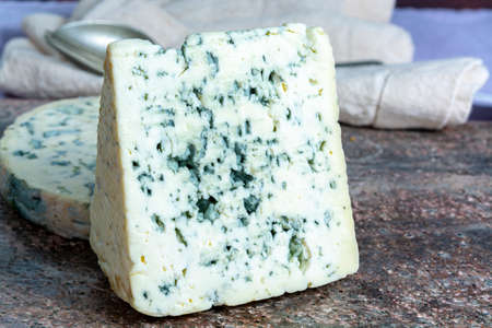 Pieces of Fourme Ambert and Blue Auvergne semi-hard AOP French blue cheeses made from raw cow milk in Auvergne, Franceの写真素材
