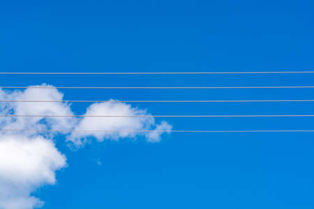 Empty music staff concept photo of 5 electric wires on blue sky, music creation template copy spaceの写真素材
