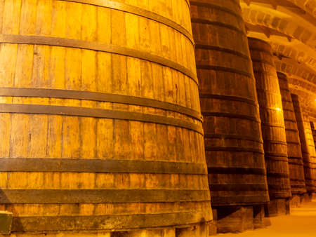 Vintage wine cellar with old oak barrels, production of fortified dry or sweet tasty marsala wine in...