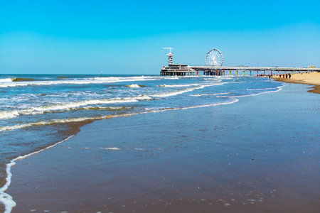 Sunny day on North sea beach in Netherlands near Schegeningen, tourist and vacation destination in Europeのeditorial素材