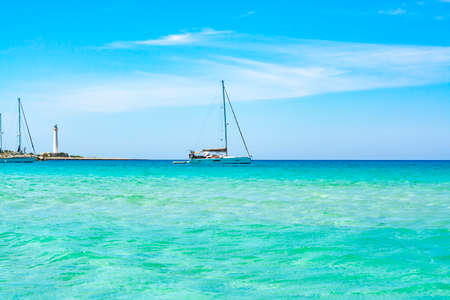 Crystal clear light blue water on sandy beach San Vito lo Capo, Sicily, Italy in sunny dayの写真素材