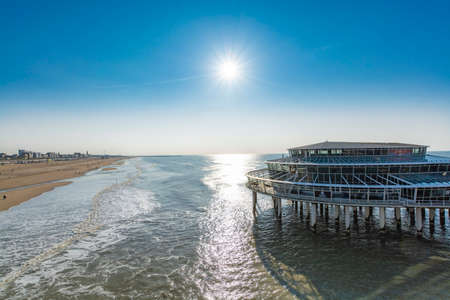 Sunny day on North sea beach in Netherlands in Scheveningen, tourist and vacation destinationの写真素材