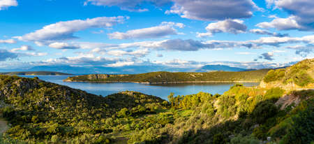 Panorama photo with scenic coastline on Peloponnese, Greece, green hills and blue sea water