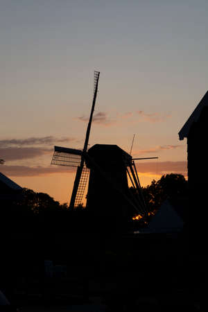 Black silhouette of traditional Dutch windmill in twilight  copy space