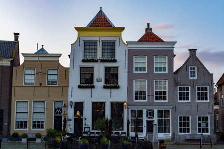 Street view with old houses in small Dutch town Goedereede on sunset, Zeeland, Netherlands