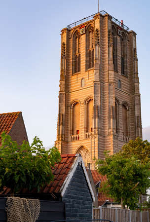 Street view with old houses in small Dutch town Goedereede on sunset, Zeeland, Netherlandsの写真素材