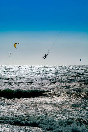 Water sport event, colorful kite surfers race in North Sea near Renesse, Zeeland, Netherlandsの写真素材