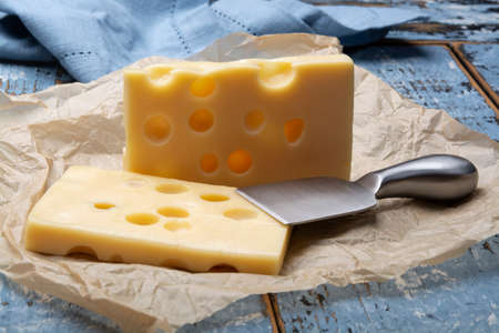 Two blocks of French emmental semi-hard cheese close up