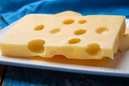 Two blocks of French emmental semi-hard cheese close up
