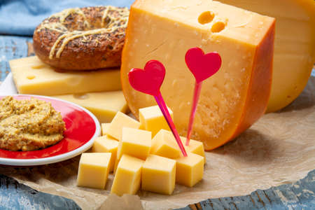 Love Dutch cheese concept, blocks of young and aged Gouda hard cheese close upの写真素材
