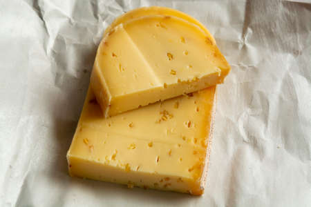 cow's milk cheese with fenugreek seeds made in Belgian abbey by monks.