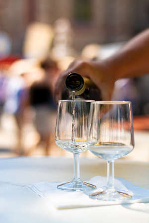 Tasting of cold white dry riesling wine on street wine festival on Mosel river, Germany, grape harvest festivalの写真素材