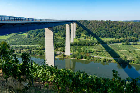 Panoramic view on high freeway viaduct bridge across Mosel river valley and terraced vineyards, road network and transportation is Germanyの写真素材