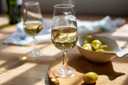 Sherry wine tasting, dry fino  jerez fortified wine made from palamino white grapes and olives with garlic, El Puerto de Santa Maria, Andalusia, Spainの写真素材