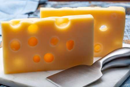 Two blocks of French emmental semi-hard cheese close upの写真素材