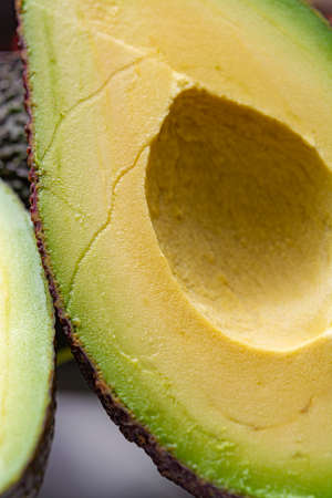 Macro photo, fresh ripe organic hass avocado, cut in half
