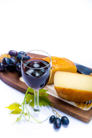 Hard Italian pecorino sheep cheese and glass with Italian red wine close up on white backgroundの写真素材