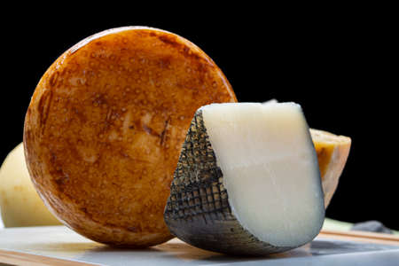 Cheese collection, Variety of Italian pecorino cheeses, aged with black peppers from Nebrodi, white Il Palio and black molarotto, close upの写真素材