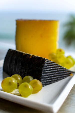 Spanish sheep cheese served with white outside with sea view close up