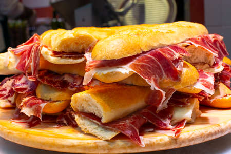 Spanish tapas street food, bocadillo fresh bread with jamon iberico ready to eatの写真素材