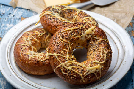Tasty baked bagels with melted french emmental cheese  close upの写真素材