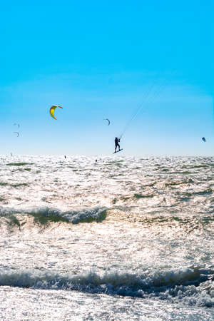 Water sport event, colorful kite surfers race in North Sea near Renesse, Zeeland, Netherlandsの写真素材