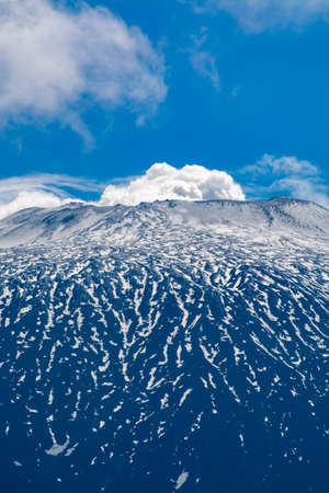 View on active stratovolcano Mount Etna on east coast of island Sicily, Italy in springの写真素材