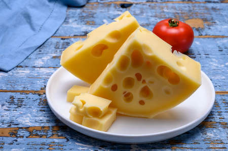 Cheese collection, french hard cheese with holes emmentaler close upの写真素材