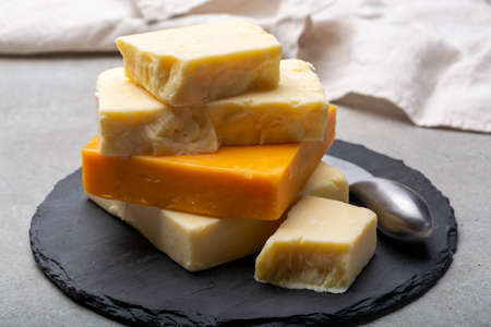 Cheese collection, matured and orange original British cheddar cheese in blocks served with crackers...