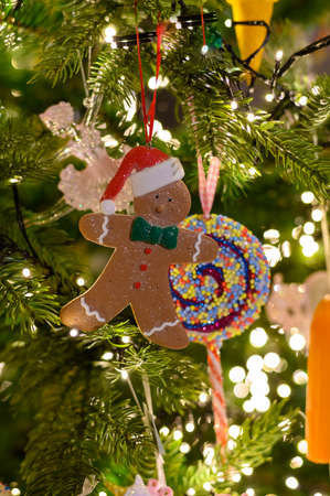 Christmas tree decorated is festivily decorated with vintage gingerbread men cookie, garlands and...