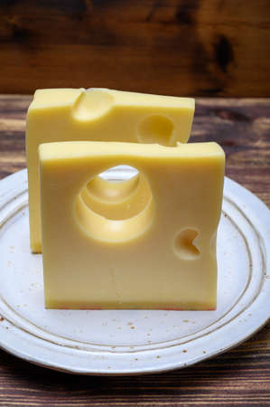 Cheese collection, swiss emmentaler cheese with big holes close up