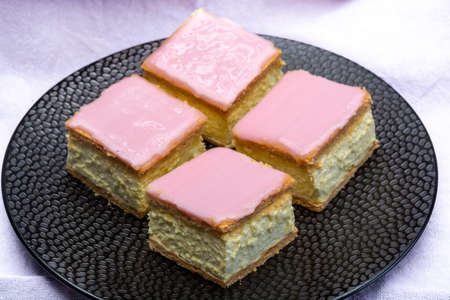 Tompoes or tompouce, iconic pastry in Netherlands and Belgium made from puff dough, icing, cream close upの写真素材