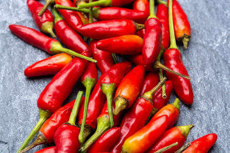Fresh small red hot chili peppers on grey background close upの写真素材