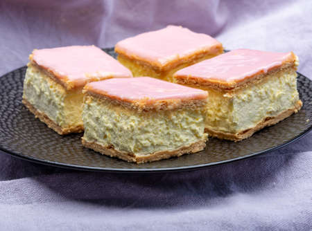 Tompoes or tompouce, iconic pastry in Netherlands and Belgium made from puff dough, icing, cream close upの写真素材