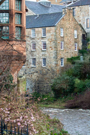 View on old houses in Dean village and Leith river in New Town part of Edinburgh city, capital of...