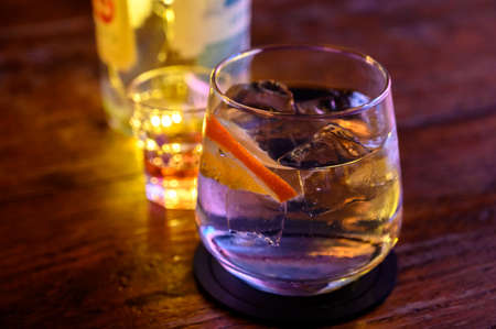Glass of gin with tonic water, orange and ice close upの写真素材